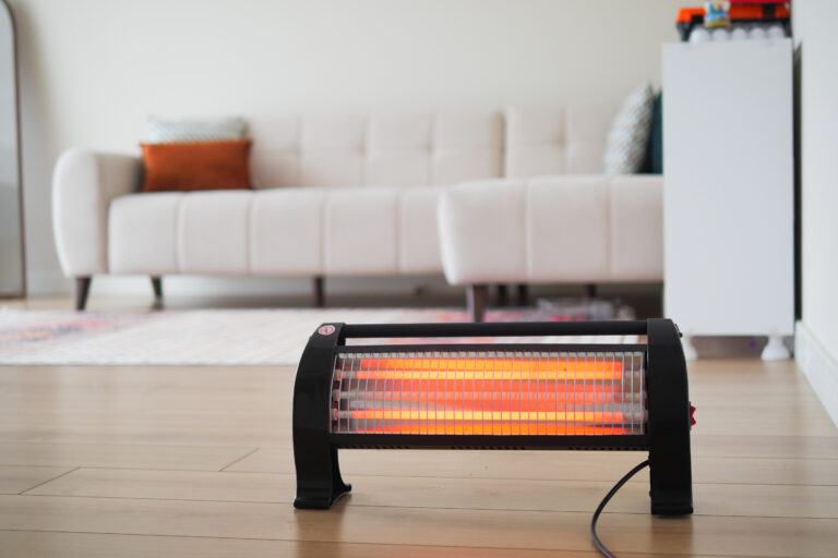 Modern electric infrared heater in living room, closeup. High quality photo